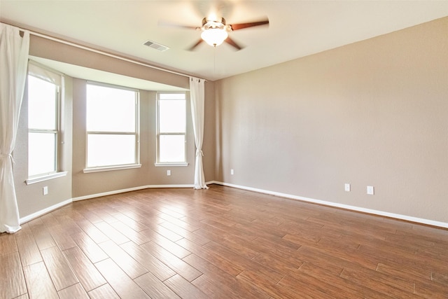 unfurnished room featuring ceiling fan and hardwood / wood-style floors