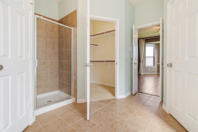 bathroom with tile patterned flooring and a shower with shower door