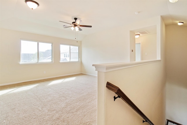 unfurnished living room featuring carpet and ceiling fan