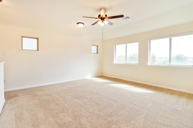 carpeted empty room featuring ceiling fan