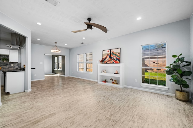 living room with wood-type flooring and ceiling fan