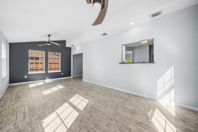 unfurnished living room featuring ceiling fan, hardwood / wood-style floors, and vaulted ceiling