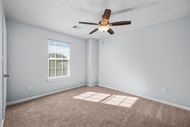 spare room featuring carpet flooring and ceiling fan