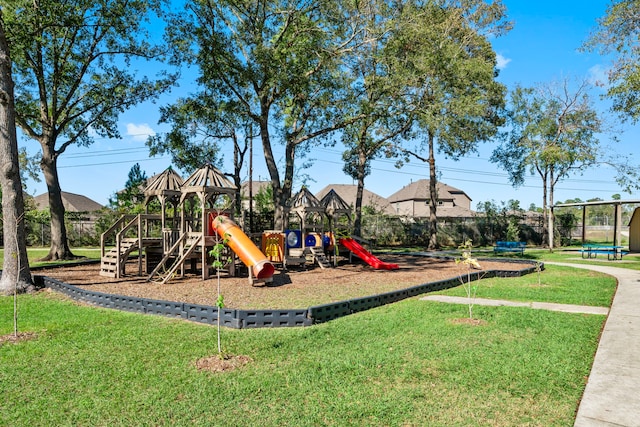 view of jungle gym featuring a lawn