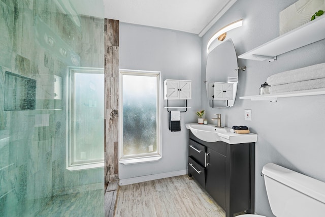 bathroom featuring a shower, toilet, vanity, and hardwood / wood-style flooring