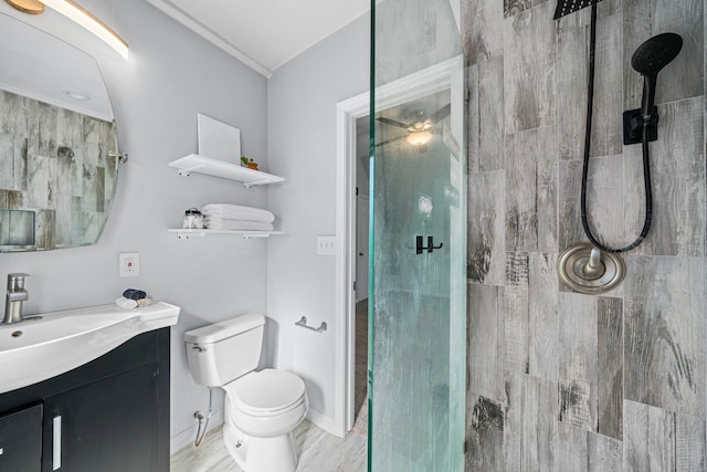 bathroom with wood-type flooring, vanity, toilet, and a shower with door