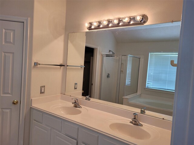 bathroom with vanity and separate shower and tub