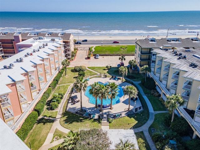 drone / aerial view with a water view and a beach view