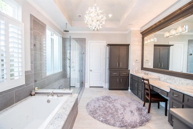 bathroom with an inviting chandelier, separate shower and tub, a tray ceiling, vanity, and ornamental molding