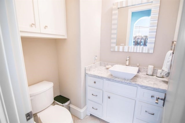 bathroom with tile patterned flooring, vanity, and toilet