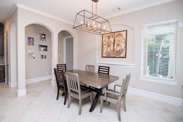 dining space featuring crown molding, light tile patterned floors, and an inviting chandelier