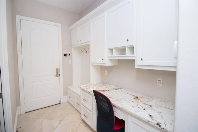 home office with light tile patterned floors and built in desk