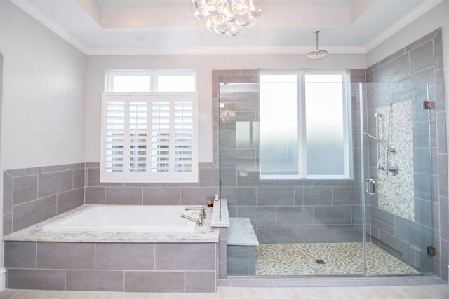 bathroom featuring a raised ceiling, crown molding, a notable chandelier, and shower with separate bathtub