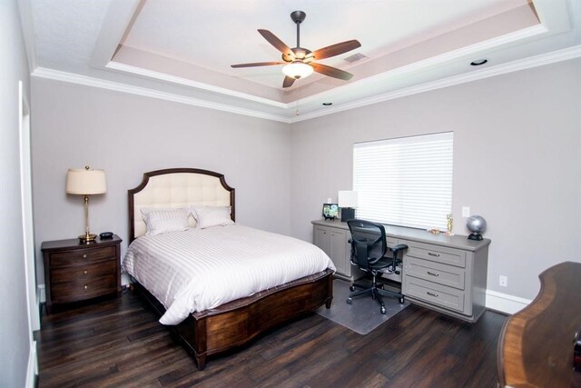 bedroom featuring dark hardwood / wood-style flooring, a raised ceiling, ceiling fan, and ornamental molding