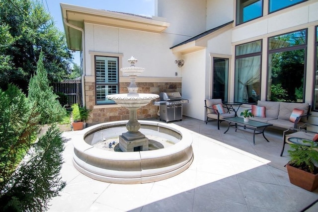 view of patio with outdoor lounge area and a grill