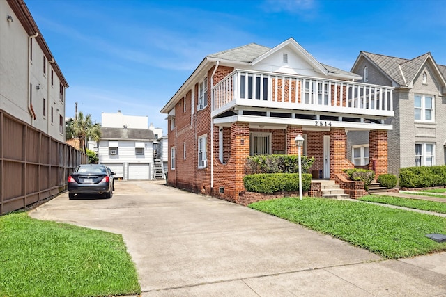 view of front of property with a front yard and a balcony