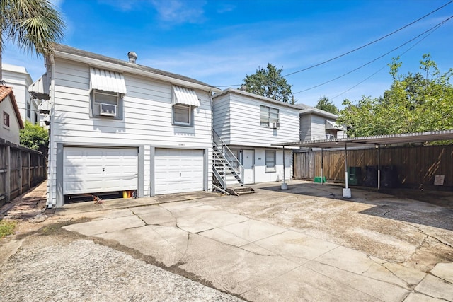 rear view of property featuring a garage