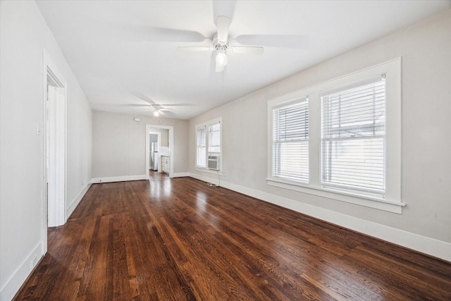 empty room with ceiling fan and dark hardwood / wood-style flooring