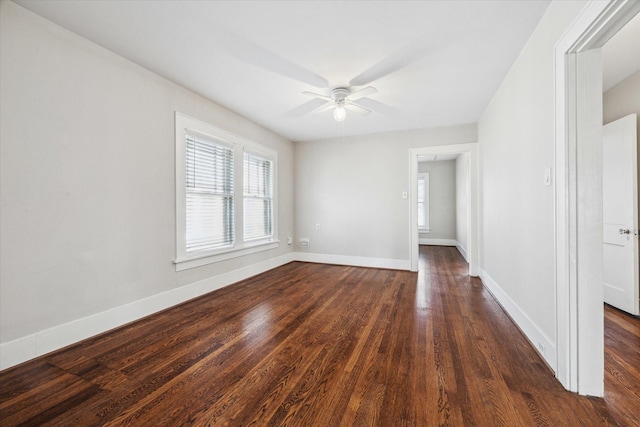 spare room featuring dark hardwood / wood-style flooring and ceiling fan