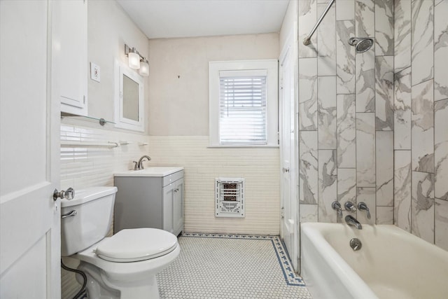 full bathroom with tiled shower / bath, heating unit, tile walls, vanity, and toilet