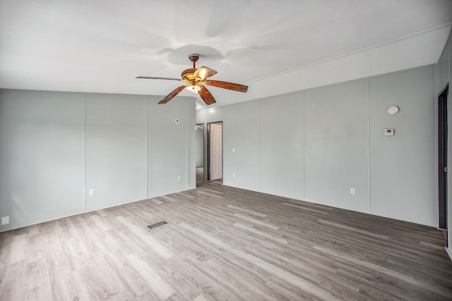 spare room featuring a textured ceiling, hardwood / wood-style flooring, ceiling fan, and lofted ceiling