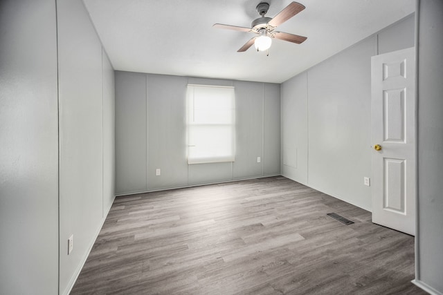 spare room with light hardwood / wood-style flooring and ceiling fan