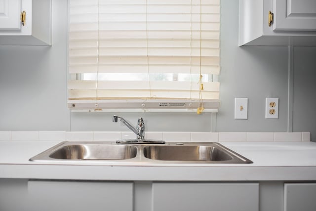 kitchen featuring sink and white cabinets