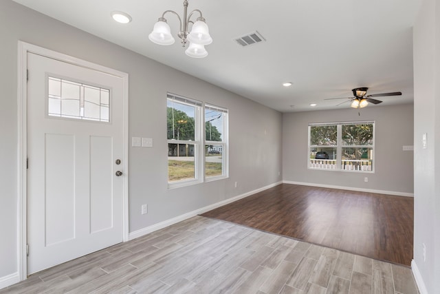 entryway featuring light hardwood / wood-style flooring and ceiling fan with notable chandelier