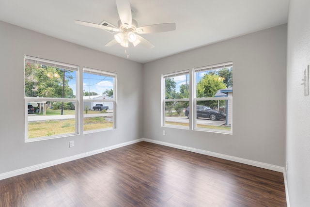 unfurnished room featuring ceiling fan and dark hardwood / wood-style flooring