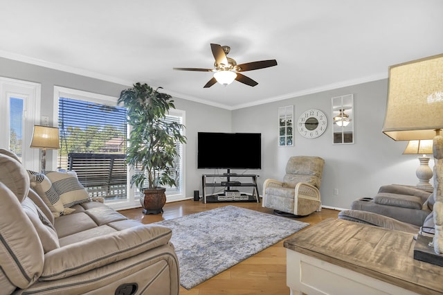 living room with ceiling fan, light wood-type flooring, and crown molding