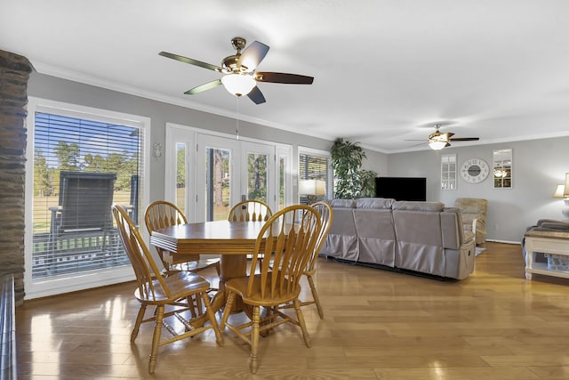 dining area featuring wood-type flooring, french doors, ceiling fan, and crown molding