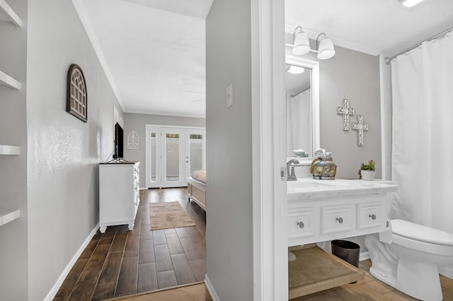 bathroom with hardwood / wood-style floors, vanity, and toilet