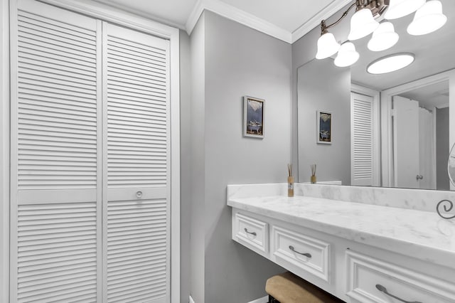 bathroom featuring a notable chandelier, vanity, and crown molding