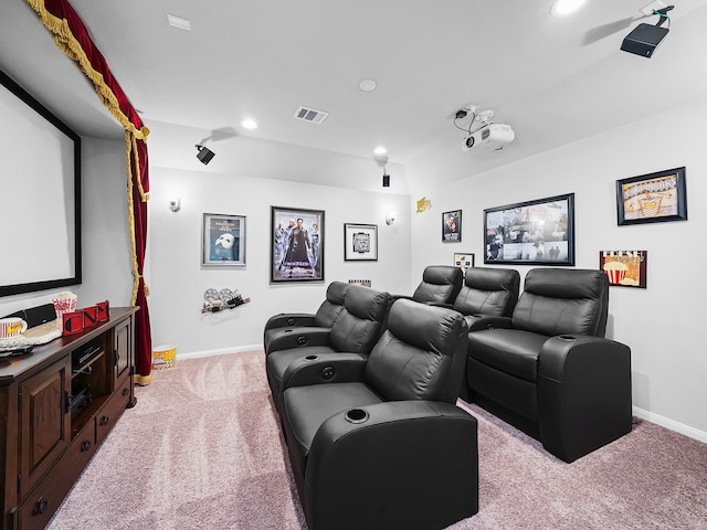 cinema room featuring light colored carpet