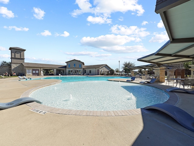 view of pool featuring pool water feature and a patio area