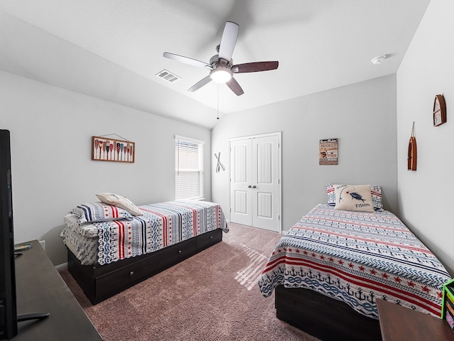 carpeted bedroom featuring lofted ceiling, ceiling fan, and a closet