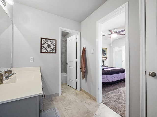 bathroom featuring ceiling fan, vanity, and shower / bath combination