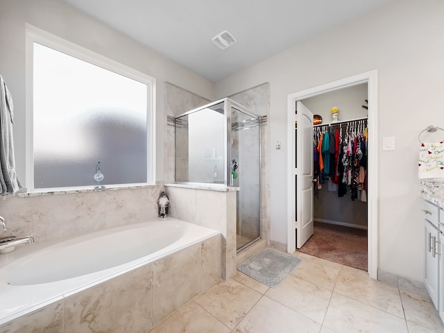 bathroom featuring vanity, separate shower and tub, and tile patterned flooring