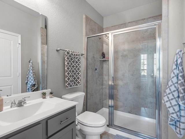 bathroom with vanity, toilet, and an enclosed shower