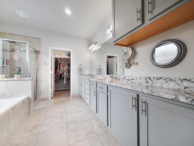 bathroom featuring vanity, tile patterned floors, and plus walk in shower