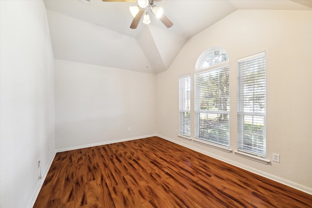 empty room featuring ceiling fan, hardwood / wood-style floors, a healthy amount of sunlight, and lofted ceiling