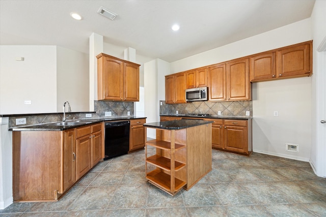 kitchen featuring dishwasher, a center island, backsplash, and dark stone countertops