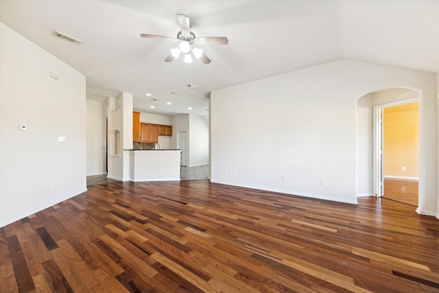 unfurnished living room featuring ceiling fan, dark wood-type flooring, and vaulted ceiling