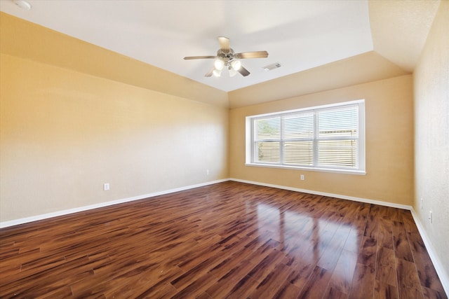 spare room featuring dark hardwood / wood-style floors, ceiling fan, and lofted ceiling