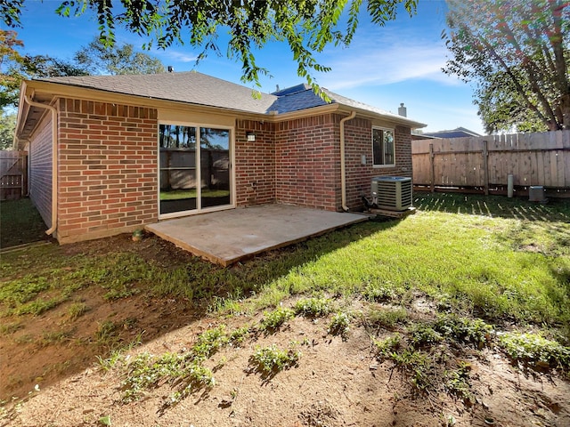 back of property featuring a patio area, a yard, and cooling unit