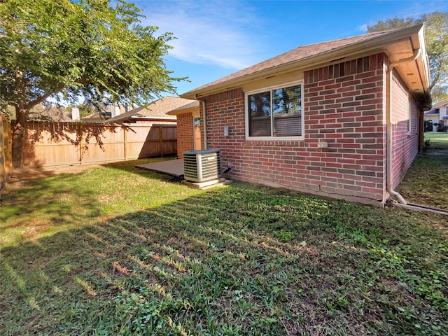 back of house with a lawn and cooling unit