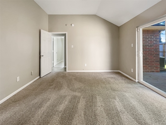 spare room with carpet floors and lofted ceiling