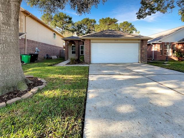 single story home with a garage and a front yard