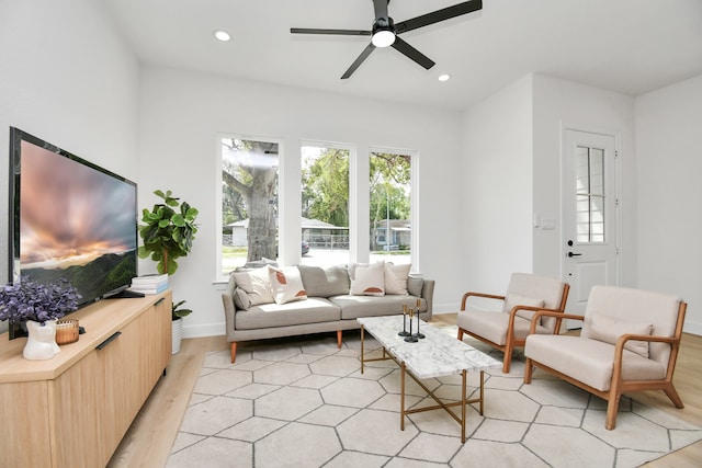 living room featuring ceiling fan and light hardwood / wood-style floors