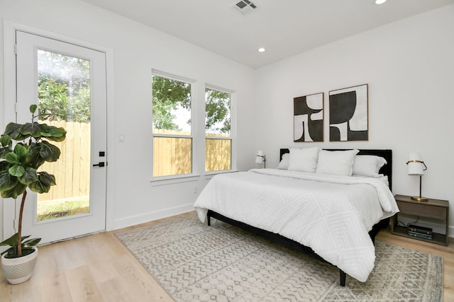 bedroom featuring wood-type flooring and multiple windows